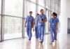 Operation Nightingale Stuns Healthcare Kia Nurse walking with fellow medical staff in hospital corridor