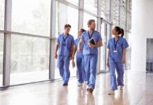 Operation Nightingale Stuns Healthcare Kia Nurse walking with fellow medical staff in hospital corridor