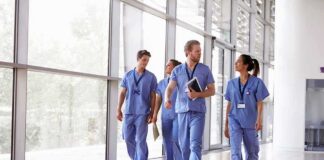 Kia Nurse walking with fellow medical staff in hospital corridor
