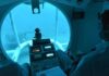 Titan Implosion Probe Exposes OceanGate’s Safety Failures submarine interior with pilot viewing seafloor through large window