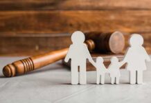 Paper cutout family with gavel in background