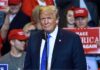 Chaos Erupts: Protesters Flood Trump Rally Donald Trump at a rally speaking at a microphone
