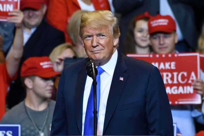 Donald Trump at a rally speaking at a microphone