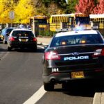Florida Bus Disaster Stuns Parents Police cars with lights on near school buses on a city street