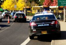 Florida Bus Disaster Stuns Parents Police cars with lights on near school buses on a city street