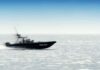 Fiery Reentry Drama Grips NASA Police patrol boat speeding across open water