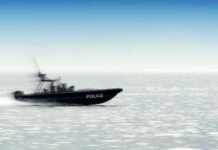 Police patrol boat speeding across open water