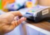Hand inserting credit card into point-of-sale terminal