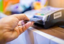 Hand inserting credit card into point-of-sale terminal