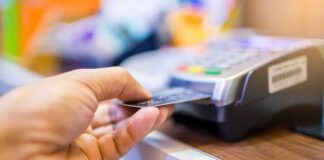 Hand inserting credit card into point-of-sale terminal