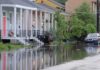 Storm Surge Swallows Carolina Main Streets Person walking through flooded residential street
