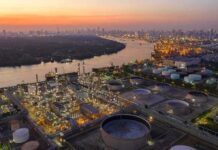 Drone Inferno Engulfs St. Petersburg Industrial oil refinery complex beside a river at dusk