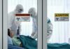 Ebola Alarm: Kenya Finds Third Case Healthcare workers in hazmat suits treat a patient in a quarantine room
