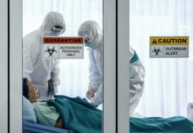 Ebola Alarm: Kenya Finds Third Case Healthcare workers in hazmat suits treat a patient in a quarantine room
