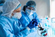 Mobile Labs Are Changing Ebola Response Scientists in protective gear working with a syringe in a laboratory