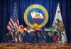 Office Mandate Triggers Wild Stateworker Revolt Press microphones at a podium before California governor seal