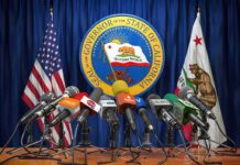 Office Mandate Triggers Wild Stateworker Revolt Press microphones at a podium before California governor seal