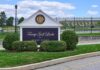 County Fast-Tracks Trump Retreat Deal Entrance sign at a golf course with manicured shrubs
