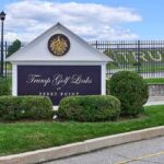 County Fast-Tracks Trump Retreat Deal Entrance sign at a golf course with manicured shrubs
