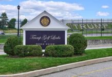 Entrance sign at a golf course with manicured shrubs