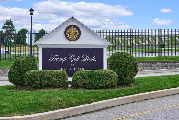 Entrance sign at a golf course with manicured shrubs