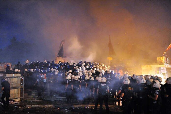 Istanbul,-,Jun,11:,In,Taksim,Gezi,Park,,Protests,Sparked Riot police gather amid smoke at night