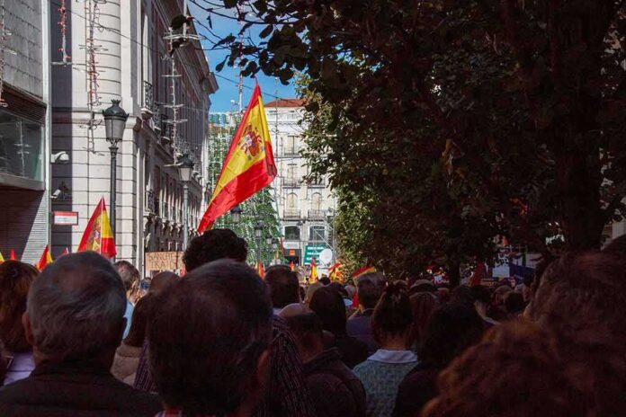 Crowd with Spanish flags in a city street