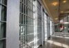 Prison cell block with metal bars and corridor