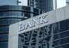 Bank building facade with large sign and glass windows